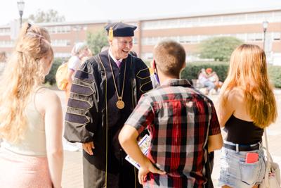 President Kaufman Laughing With A Group Of Students