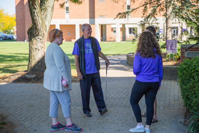 President Kaufman Talking To Students Playing Putt Putt