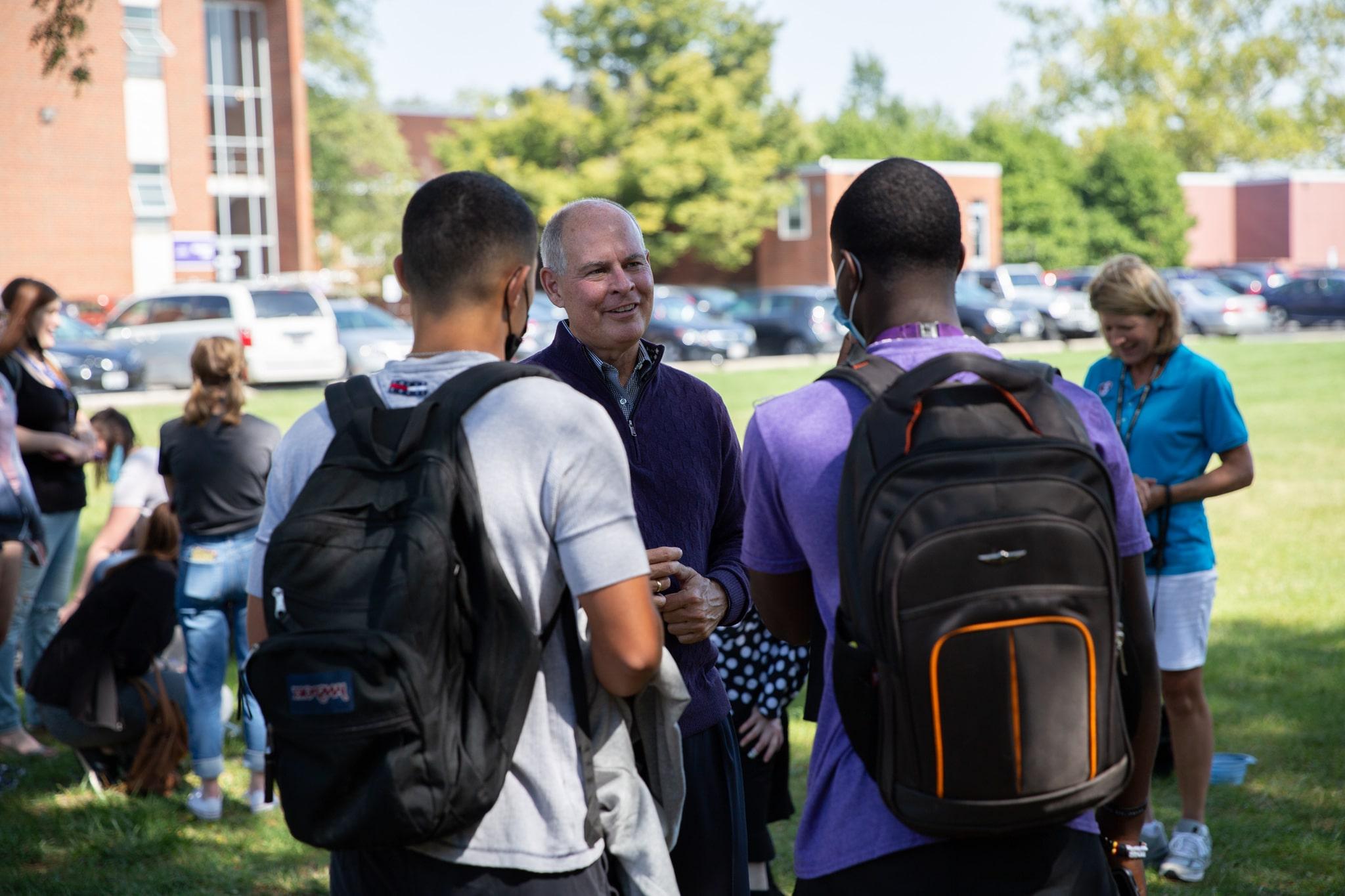 President Kaufman Talking With Two Students